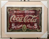 Front view of the Coca-Cola picture showing the vintage advertising graphic with corner protectors in place