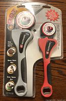 Front view of unopened set showing two grip wrenches with ergonomic handles in black and red, sealed in blister pack with product information and branding.