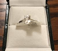 Ring in white velvet jewelry box, front view showing the morganite center stone and setting