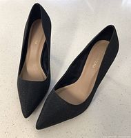 Top view of the pair of black Le Chateau dress shoes, showing pointed toes and beige insoles with brand label.