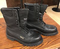 Side angle of black leather Gore-Tex Prospector boots, showing laces, padded collar, and Gore-Tex label on side.