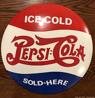 Front view of the round Pepsi-Cola metal advertising button showing colors and logo clearly.