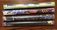 Four WWF posters rolled and sealed in original plastic, showing colorful WWF branded edges with wrestler images and titles.