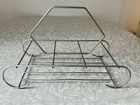 Front and top angle view of metal beverage caddy showing hexagonal handle and six glass compartments.