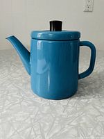 Front view of bright blue enamel kettle with lid and handle