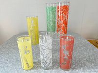 Set of nine Tom Collins glasses displayed on table.
