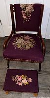 Full view of antique prayer chair with purple needlepoint floral upholstery on seat and backrest and matching kneeler in front