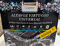 Box packaging showing the product name 'Altavoz Virtuoso Universal' and product attributes such as Bluetooth, music sync, four included songs, and indoor/outdoor use.