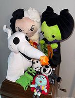 Plush Halloween Greeters including Cruella deVille, Maleficent, and Zero ghost dog, showing their full figures and tags.
