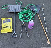 Full lot view showing all outdoor items including shovel, hose, rake, clippers, salt bag, and de-icer bottle