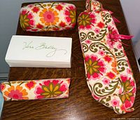 Photo of 4 Vera Bradley accessories: 1 makeup bag, 2 eyeglass cases, 1 lipstick holder in vibrant floral print
