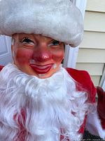 Front close-up photo of Harold Gale Santa head and upper chest showing painted face with rosy cheeks and red lips, synthetic beard attached with staples, and white furry hat trim.