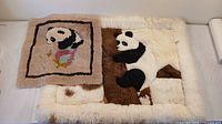 Two panda-themed alpaca wool tapestries, smaller one with framed panda and bamboo design, larger one with 3D panda figure on natural background.