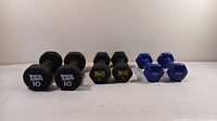 Front view of all three pairs of dumbbells showing brand and weight marking