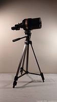 Full view of Celestron C90 telescope mounted on a tripod, showing overall size and setup