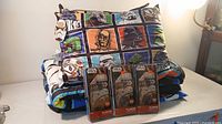 Photo of folded Star Wars comforter, two pillows with Star Wars character designs, and three mini action figures in packaging