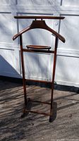 Front angle of the wooden antique suit hanger showing hanger, tray and base stand