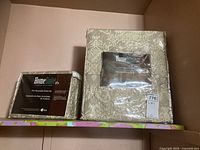 Photo showing the 4-piece reversible sheet set in original packaging with beige floral pattern and printed label.