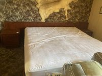 Full front view of assembled teak bed and two side tables