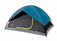 Side view of Coleman Sundome tent showing dome shape, teal blue rainfly, dark gray lower walls with light green trim.