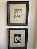 Full view of two framed contemporary portrait artworks hung vertically on a wall, showing the detailed frame and artwork size.