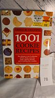 Front cover of the 1001 Cookie Recipes Cookbook by Gregg R. Gillespie showing the title and menu of cookie types, with full-color photographs of various cookies around.