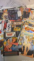 Photo showing Spider-Man 2099, Secret Agent comic book, and other assorted comics
