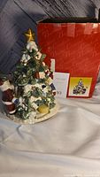 Photo showing ceramic Christmas tree figurine with Santa Claus and its original Butler box.