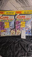 Two sealed copies of Card Collector's Price Guide Issue #24 from April 1994 shown side by side in protective bags on a black cloth background.