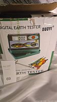 Box of Duoyi digital earth tester showing product image and brand on packaging.
