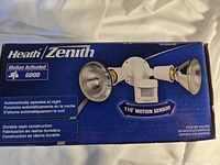 Front box showing brand, product image, and key features such as motion activation and 110° sensor angle.