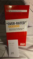 Photo of the Over-Rated party game sealed box front showing the game name and tagline.