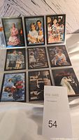 Photo showing 9 trading cards laid in a 3x3 grid in protective sleeves with portraits of Princess Diana and family