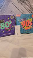 Photo showing both 'That's So 80's' and 'That's So 90's' boxed trivia games side by side, new sealed, each stating 1000 questions.