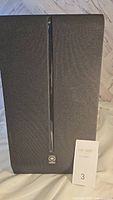 Front view of the Yamaha base speaker, black mesh front with Yamaha logo and auction lot tag number 3.