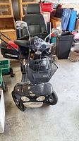 Front view of scooter showing basket, headlights, tires