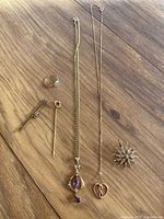 Overview of all six jewelry pieces arranged on wood background.