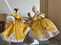 Photo of two Royal Doulton figurines The Last Waltz and Stephanie on shelf showing overall condition and style.