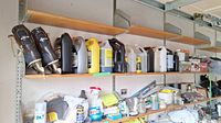 Shelf with various auto care fluids, maintenance products, and vintage ice skates on left edge.