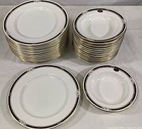 Stack of Aynsley dinner plates and soup bowls showing quantity and pattern detail