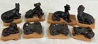 Group shot of all eight cast metal animal figurines on individual wood platforms