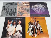 Photo showing all five vinyl records' front covers arranged together, featuring The Spinners, Commodores (two albums), Pointer Sisters, and The 5th Dimension.