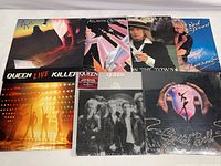 Photo shows all 7 vinyl albums with front covers visible including Rod Stewart, Queen, and Styx albums.