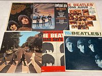 Six Beatles album covers in two rows: Rubber Soul, Something New, The Beatles’ Second Album on top; Abbey Road, A Hard Day’s Night OST, Meet The Beatles! below