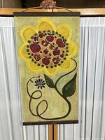 Full view of the acrylic folk art painting featuring a large yellow flower with fruits in the center on canvas.