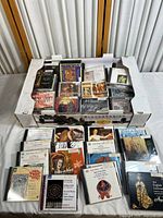 View of the box with over 30 classical and early music CDs in jewel cases, showing album artwork and titles referencing Renaissance and religious compositions.