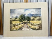 Full view of the watercolor painting showing the country road scene horizontal orientation and cream-colored matting