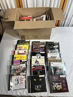 Open box showing collection of various soundtrack and musical CDs in jewel cases arranged inside for visual overview.