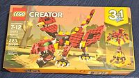 Front image of Lego Creator 31073 box showing red dragon model, age range 7-12, 223 pieces, 3-in-1 set