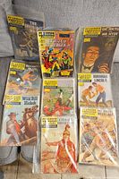 Photo of nine vintage Classics Illustrated comics arranged on a surface, showing titles and colorful covers.